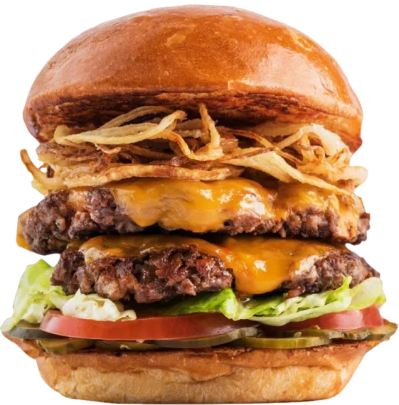 A double cheeseburger piled with crispy fried onions, lettuce and tomato on a glossy bun
